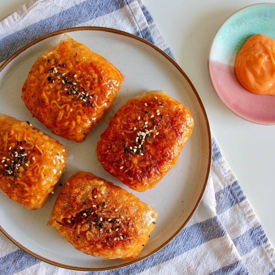Spicy Korean noodle spring rolls. Crispy rice paper spring rolls filled with Korean buldak noodles, cheese and enoki mushrooms.
