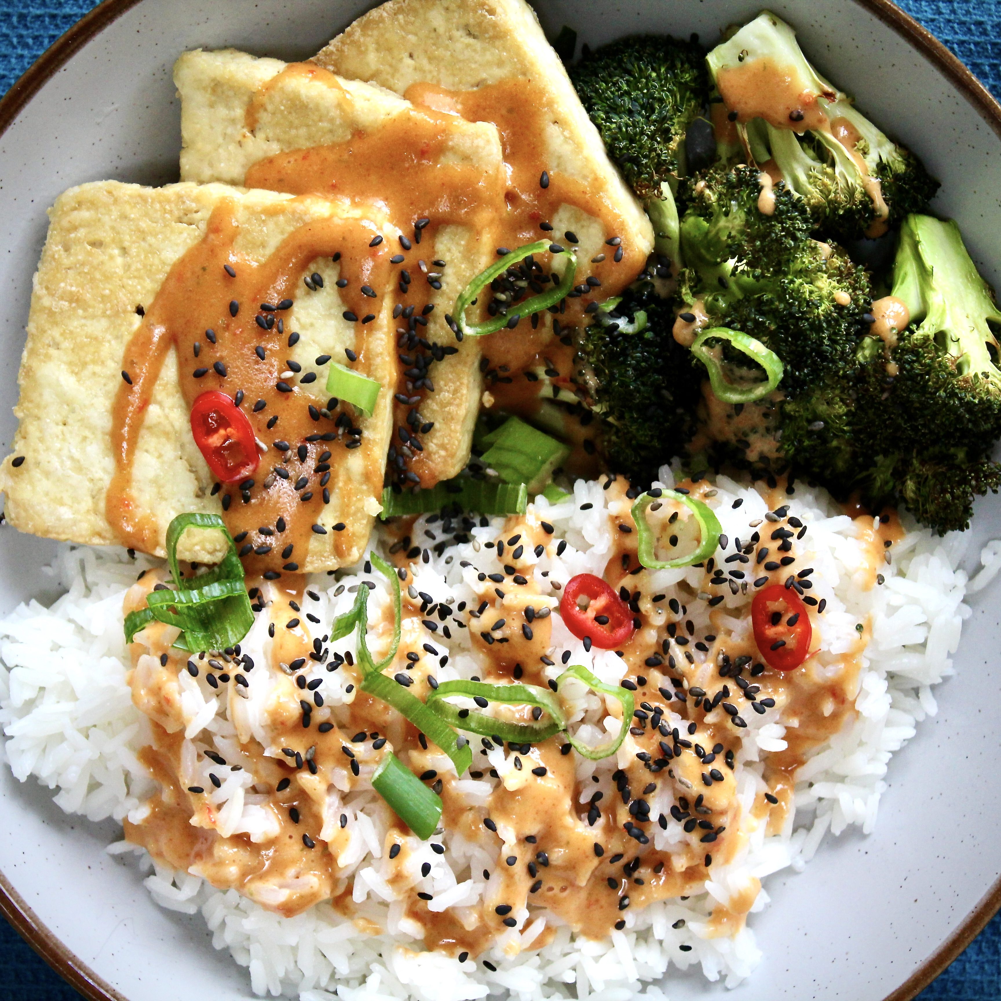 Roasted broccoli with crispy tofu and steamed jasmine rice. Served with a peanut, chilli and lime sauce.