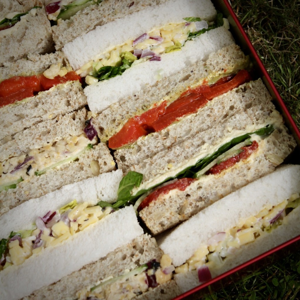 square image of vegan sandwiches in a tin