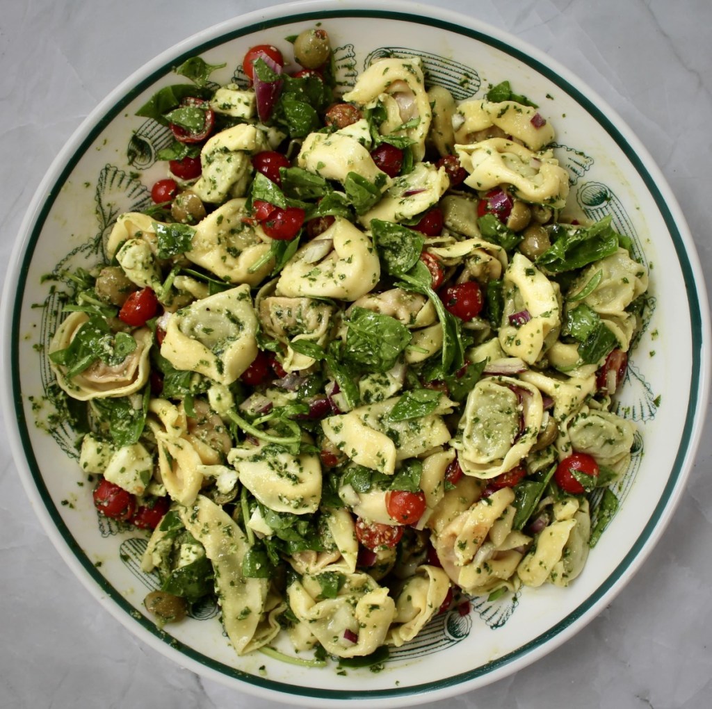 Tortellini pasta pesto salad in a large pasta bowl