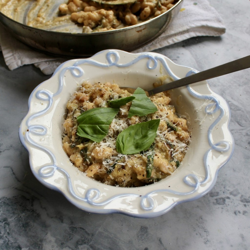 a square image of creamy beans alla nerano